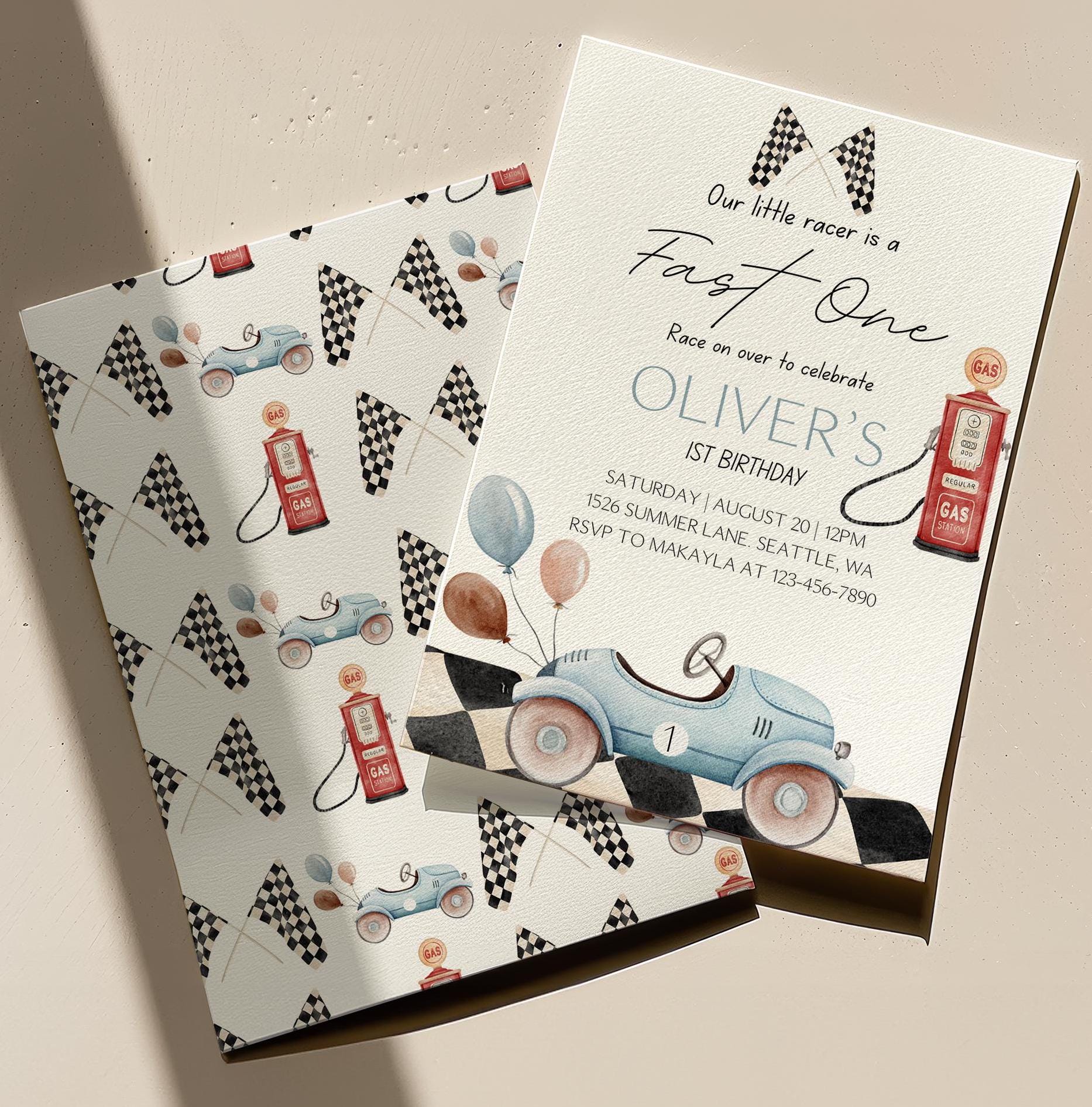 Invitation card with race car theme and checkered flags on a matching envelope.