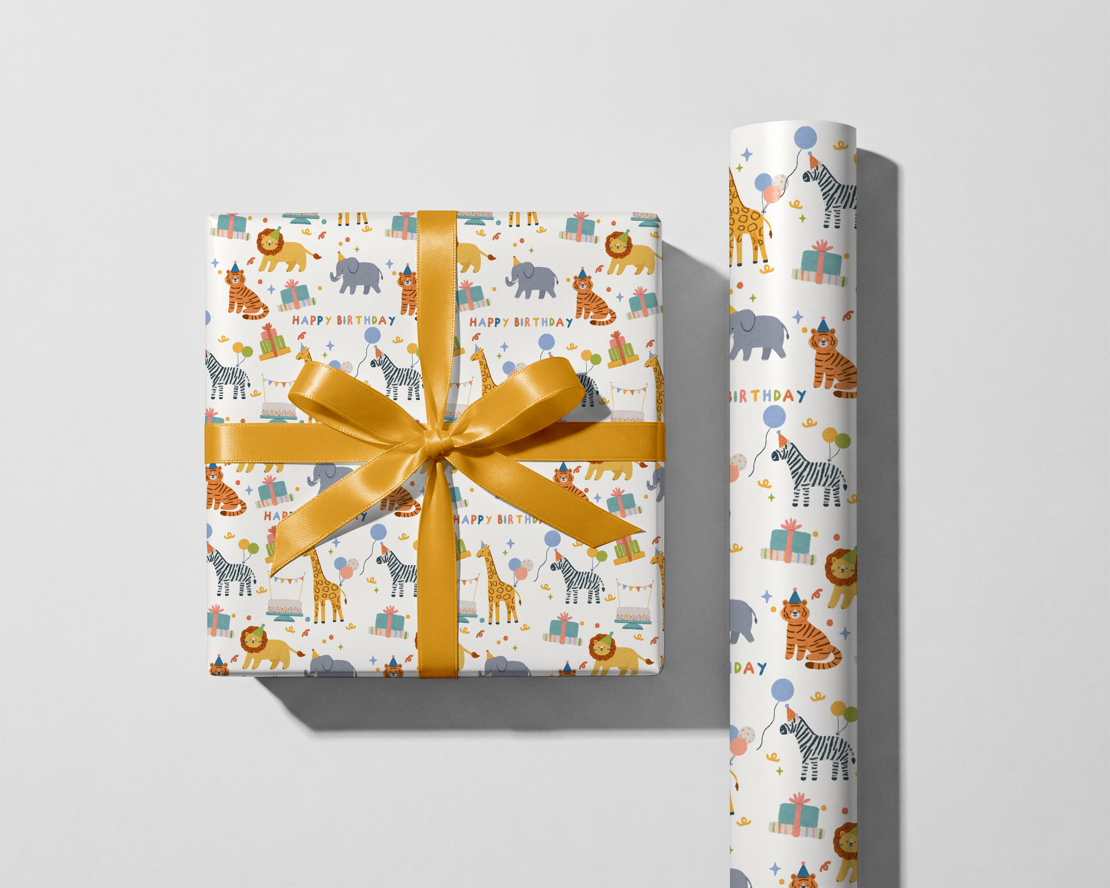 Gift wrapped in animal-themed paper with a yellow ribbon next to a roll of matching wrapping paper on a light gray background.