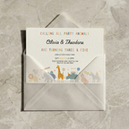 Invitation card with animal illustrations on a gray envelope against a marble background