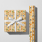 Gift wrapped in animal patterned paper with a white ribbon on a light gray background
